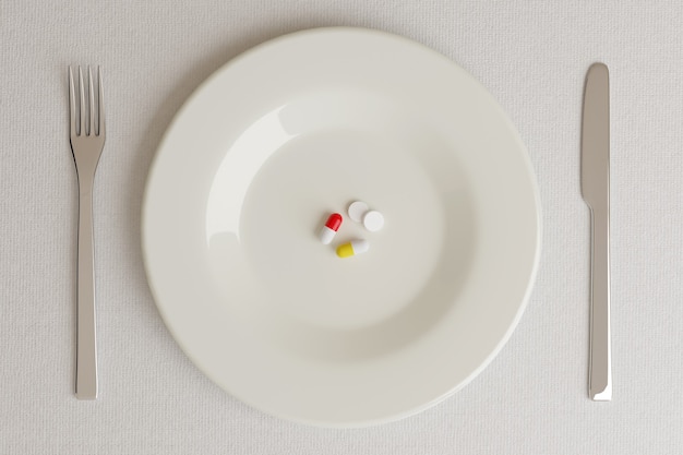 Top view of a plate with pills next to a knife and a fork on white