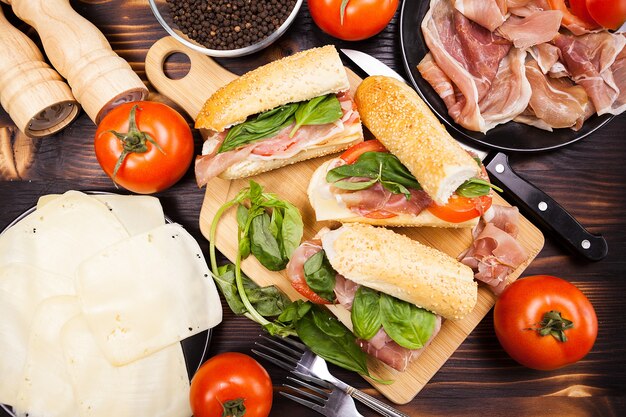 Top view of plate with sandwiches on wooden table