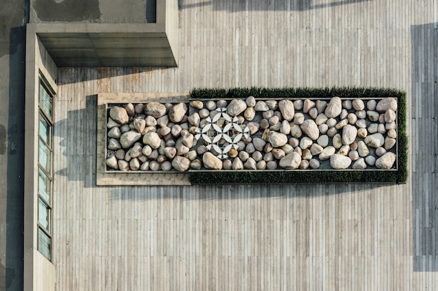 Top view of platform filled with stone on wooden rooftop. architectural decoration, outdoor platform.