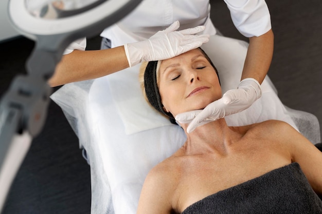 Top view of the pleasant beauty procedure with soft face massage