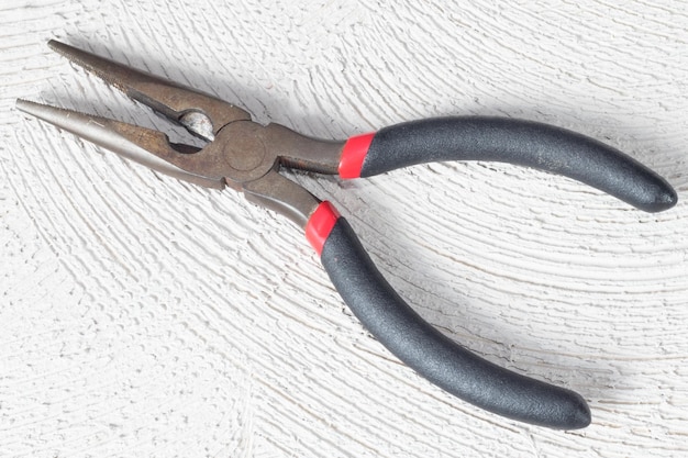 Photo top view of pliers work tool on concrete background
