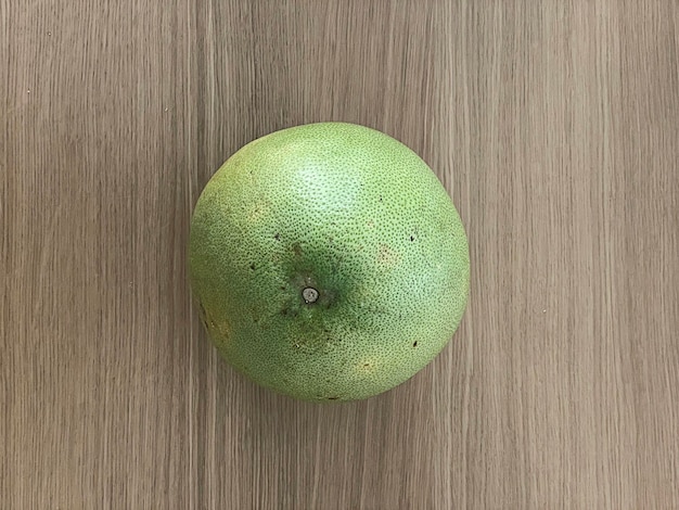 Top view of pomelo isolated on wooden table