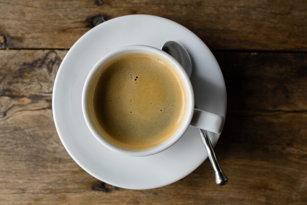 Top view portrait of hot coffee against old wooden table