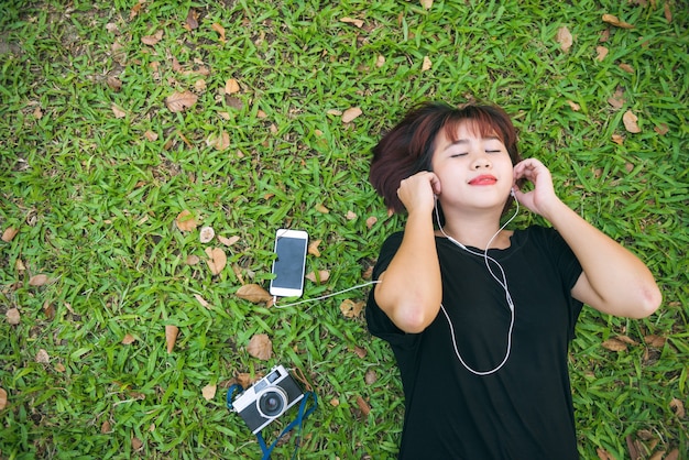 top view portrait of a pretty young woman relaxing on a grass