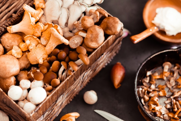 Top view of preparation and frying of edible wild mushrooms