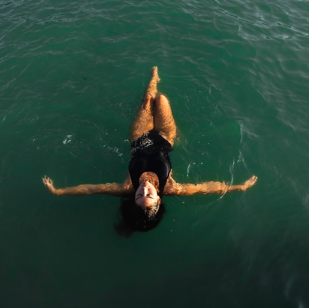 Vista dall'alto piuttosto giovane donna che gode di nuoto