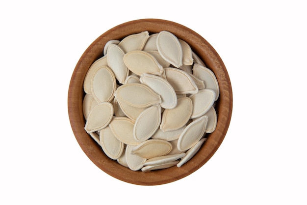 Top view of pumkin seeds in wooden bowl isolated on white background. pumkin seeds isolat.