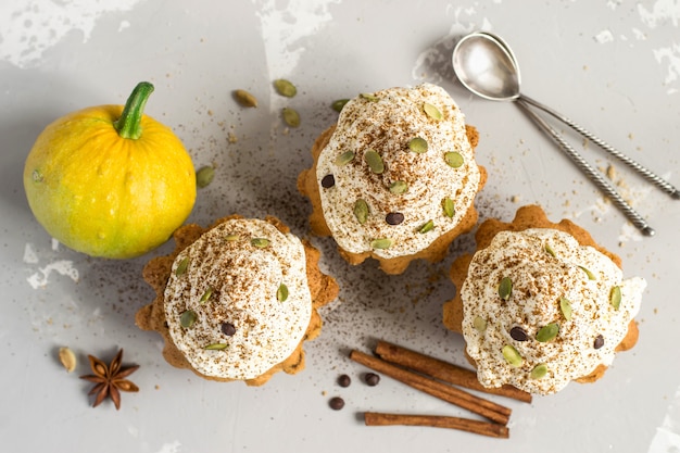 Top view of pumpkin muffins with spices, chocolate drops and pumpkin seeds