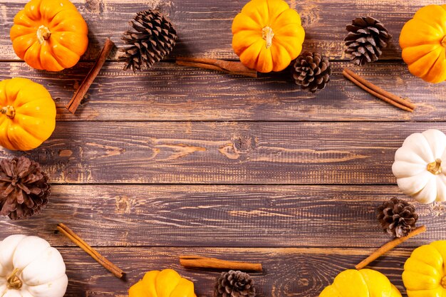 Top view of  Pumpkins and pine cone on old wooden background. 