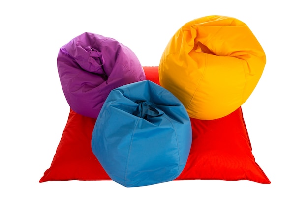 Top view on purple, blue and yellow beanbag chairs on red beanbag sofa isolated on white