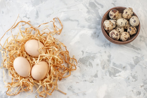 top view quail eggs and chicken eggs on table with copy place