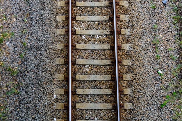 Top view of the railroad tracks on gravel