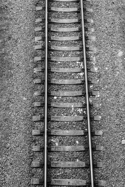 Photo top view of the railroad tracks on gravel