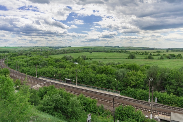 Top view of the railway tracks and a small station in the countryside in Russia