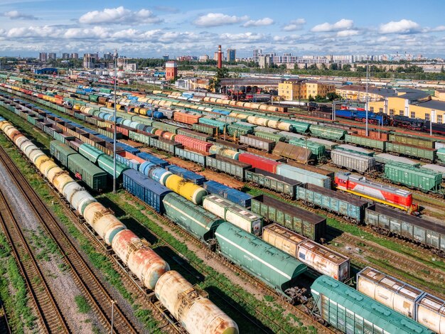 Top view on the railways with various colorful freight wagons transportation of goods by train