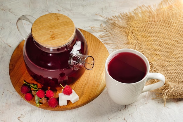 Top view on Raspberry tea in a transparent teapot with berries and sugar cubes cup of tea High quality photo