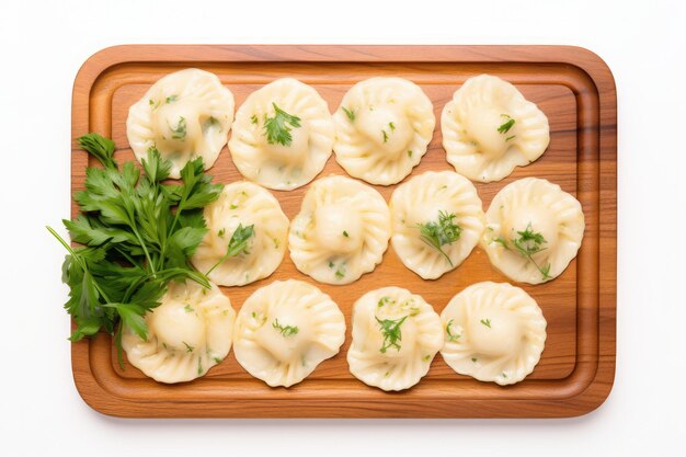 Photo top view ravioli on a wooden boardon white background