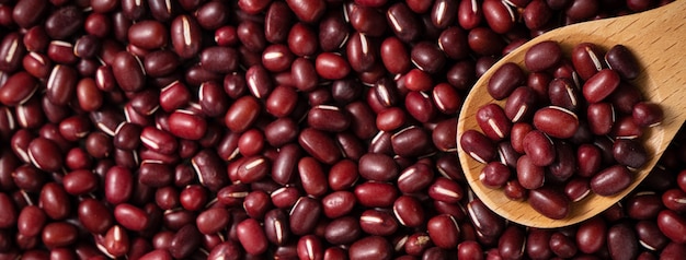 Top view of raw adzuki red bean as background with spoon.