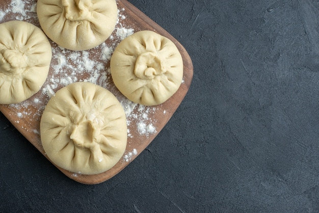 top view raw dumplings over cutting board