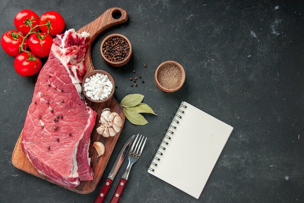 top view raw meat slice with seasonings and tomatoes. cooking dish color food meat dinner meal