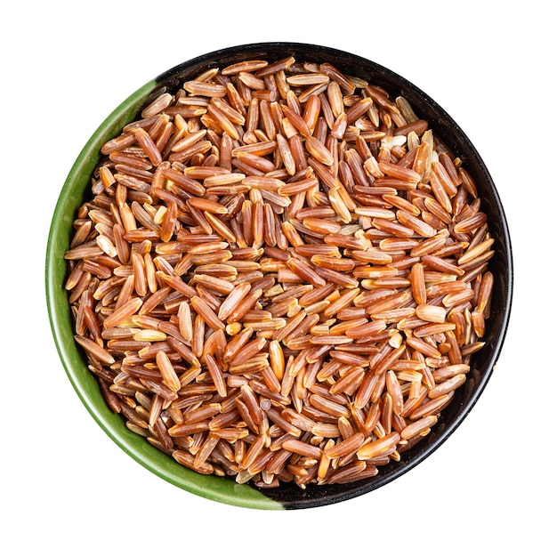 Top view of raw red rice in round bowl isolated