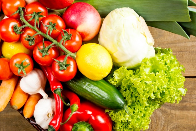 Top view of raw vegetables on wooden background