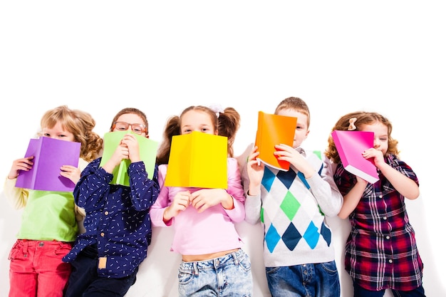 Top view of reading children, lying on the floor