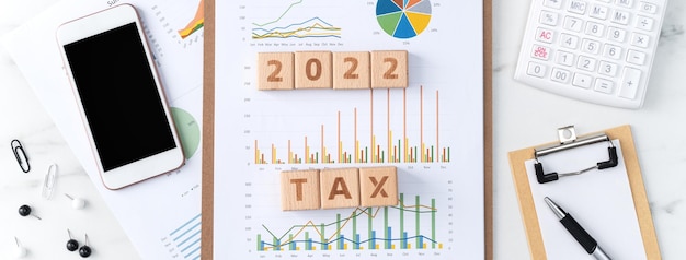 Top view of reading the overview and calculating paying tax with smart phone from internet