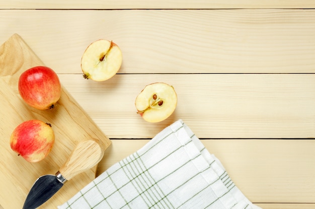 Top view red apple sliced,knife,napkin on wooden.