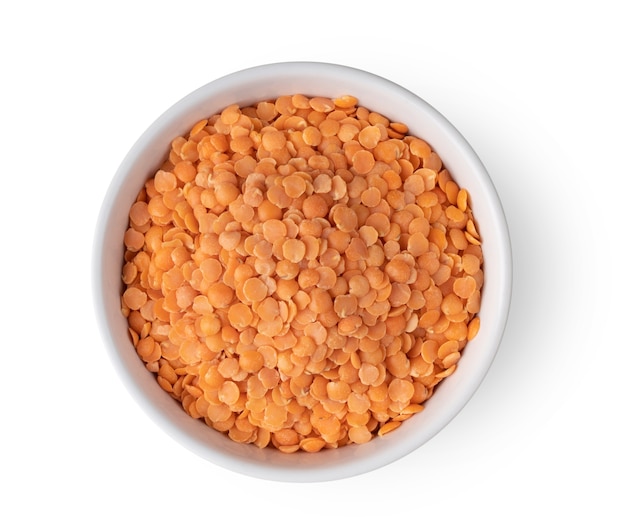 Top view red lentils in white bowl isolated on white background