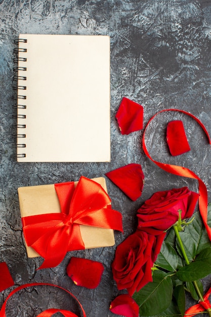 top view red roses with presents for valentines day on light gray background couple marriage passion heart love holiday feelings