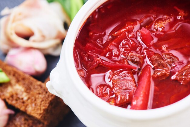 Top view of red soup in white plate closeup