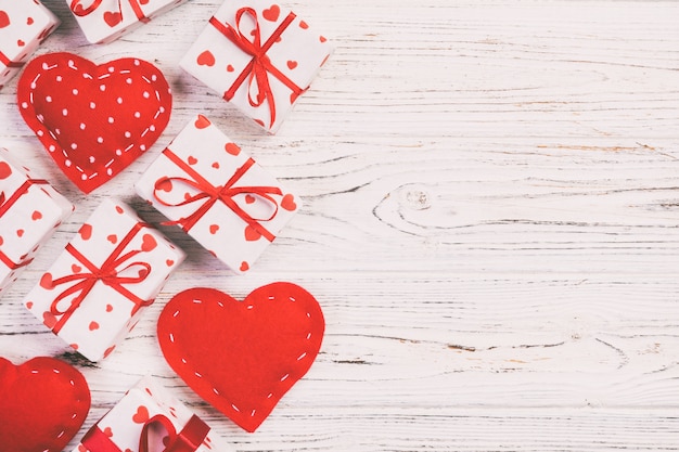 Top view of red textile hearts and gift boxes