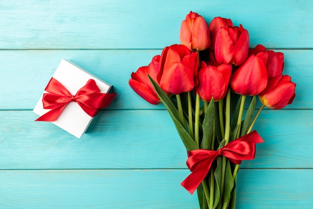 top view red tulips bouquet with ribbon