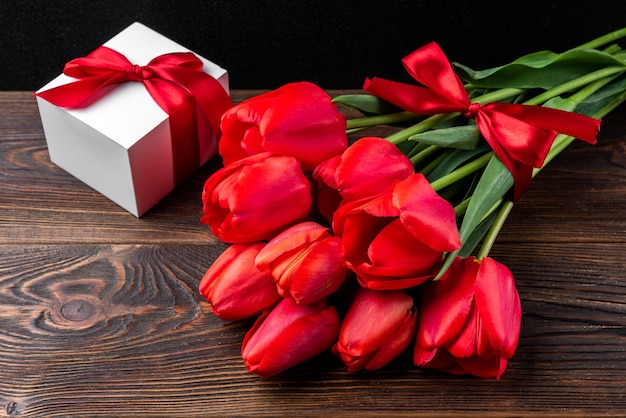 top view red tulips bouquet with ribbon