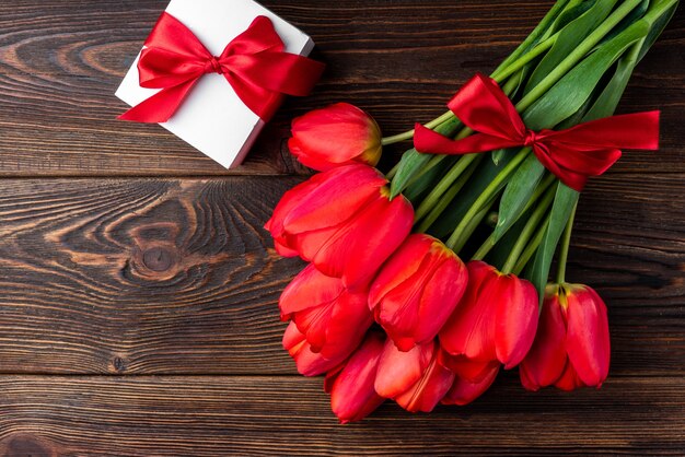 top view red tulips bouquet with ribbon