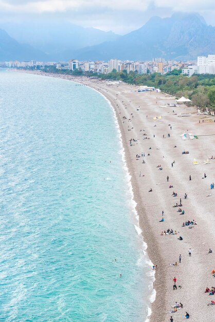 Top view of the resort town and the beach with people