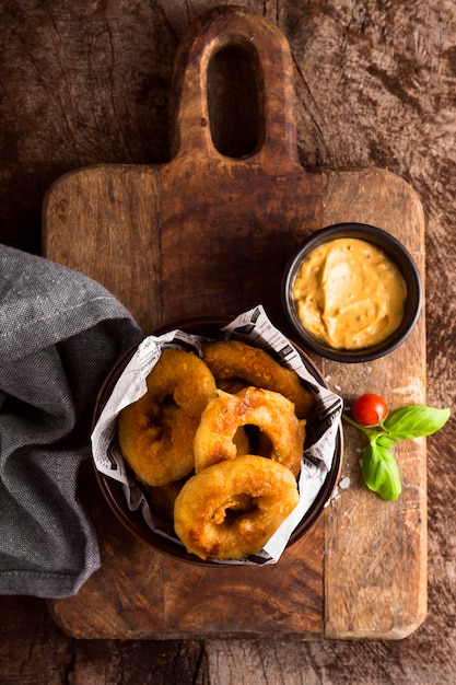 Top view of ring fries with mustard in bowl