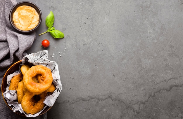 Photo top view of ring fries with mustard and copy space