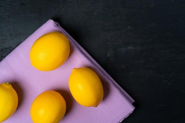 Top view of ripe lemon on black background