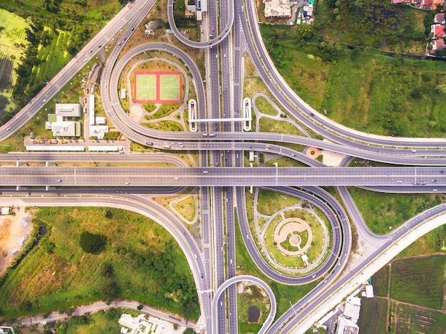 Top view over the road and highway, Aerial shot of highway interchange of a city, Shot fro