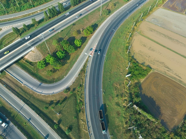 Top view of the road runway through the green Aerial view car truck drivers