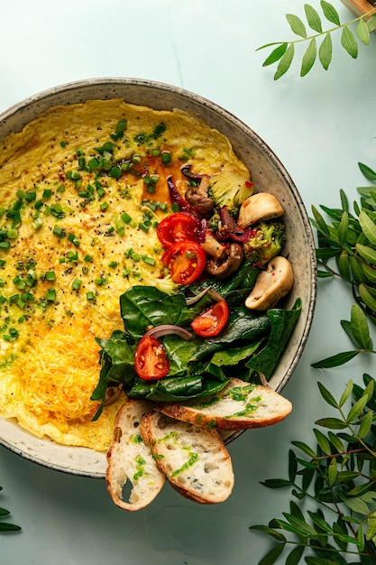 Top view on rustic omelette with vegetables and cheese