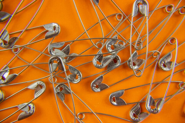 top view safety pins in orange background image