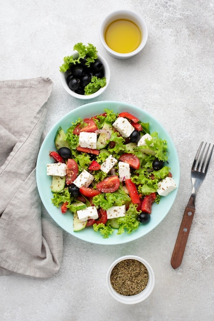 Top view salad with feta cheese, herbs and olives