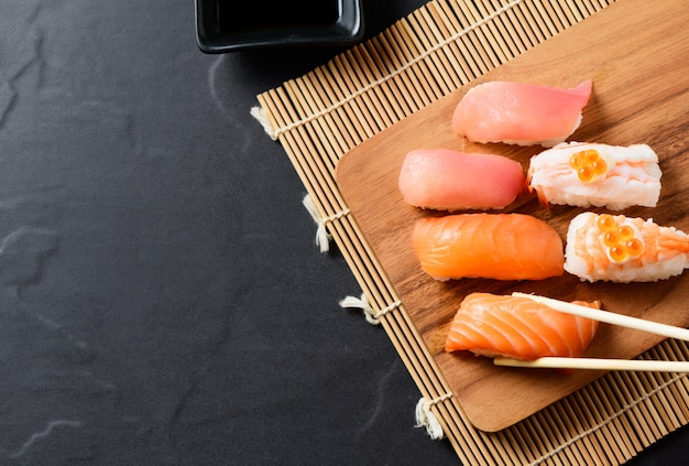 Top view of Salmon sushi nigiri in chopsticks 