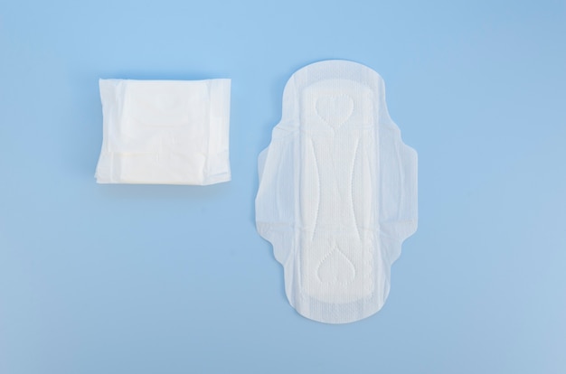 Top view sanitary napkin on blue surface