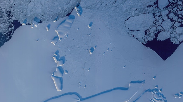 Top view satellite image of snowy icebergs in Antarctica. Elements of this image furnished by NASA.