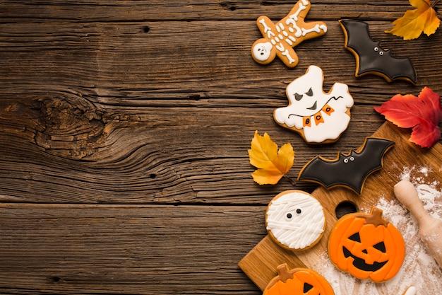 Top view scary halloween cookies on wooden background