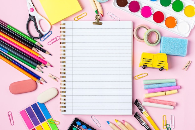 Top view of school supplies on table with copy space